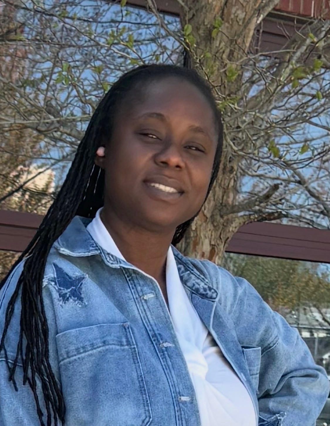 Smiling woman outdoors in denim jacket